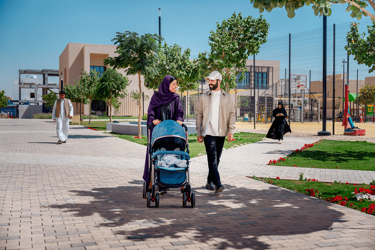 Family walking through a ROSHN Group community