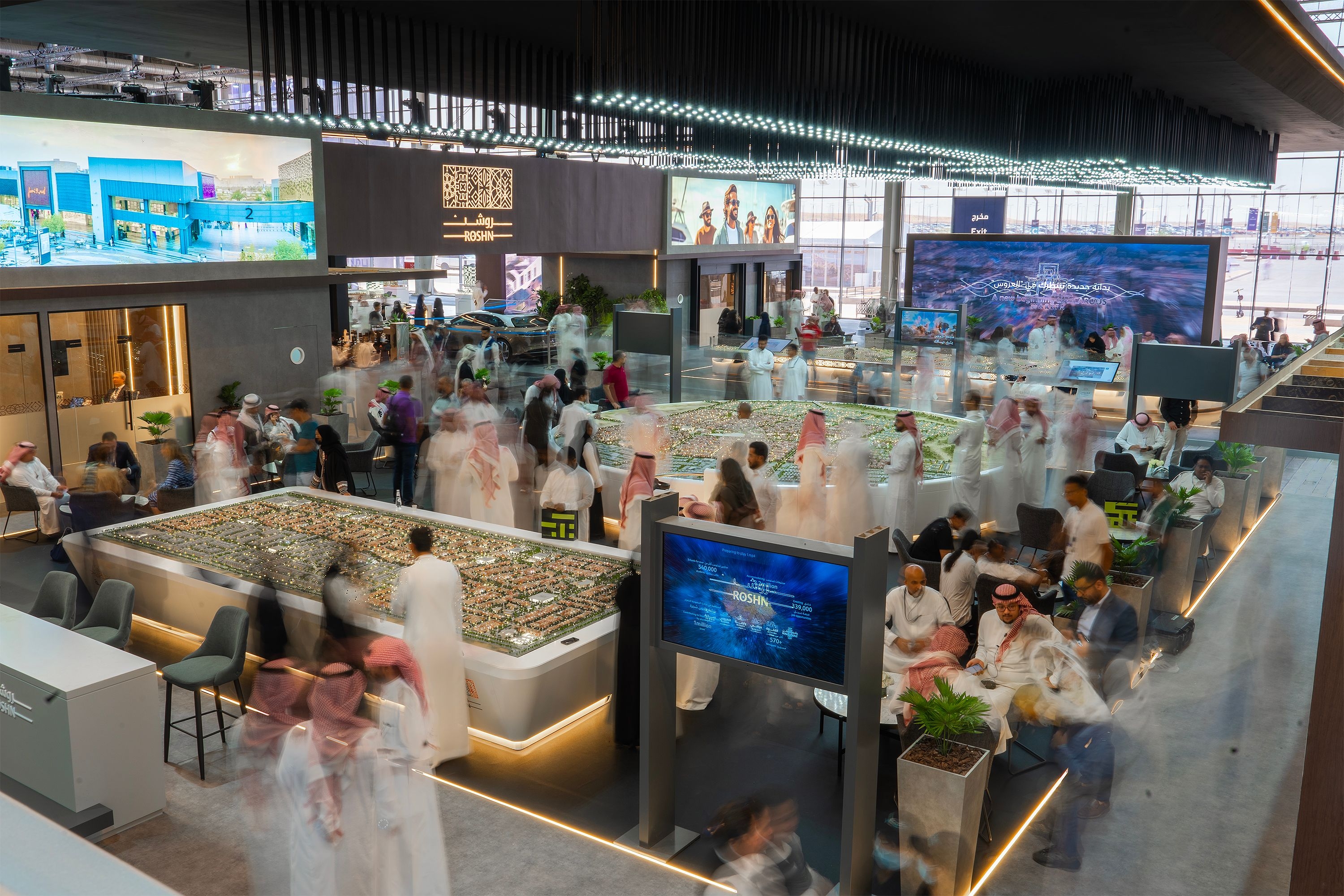 ROSHN Group booth at a community event, engaging visitors and promoting sustainable living solutions