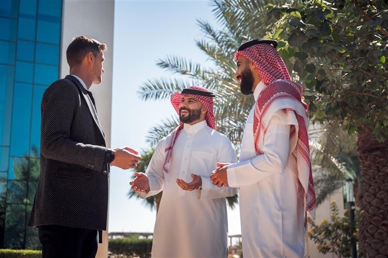 People engaged in a discussion about ROSHN Group projects