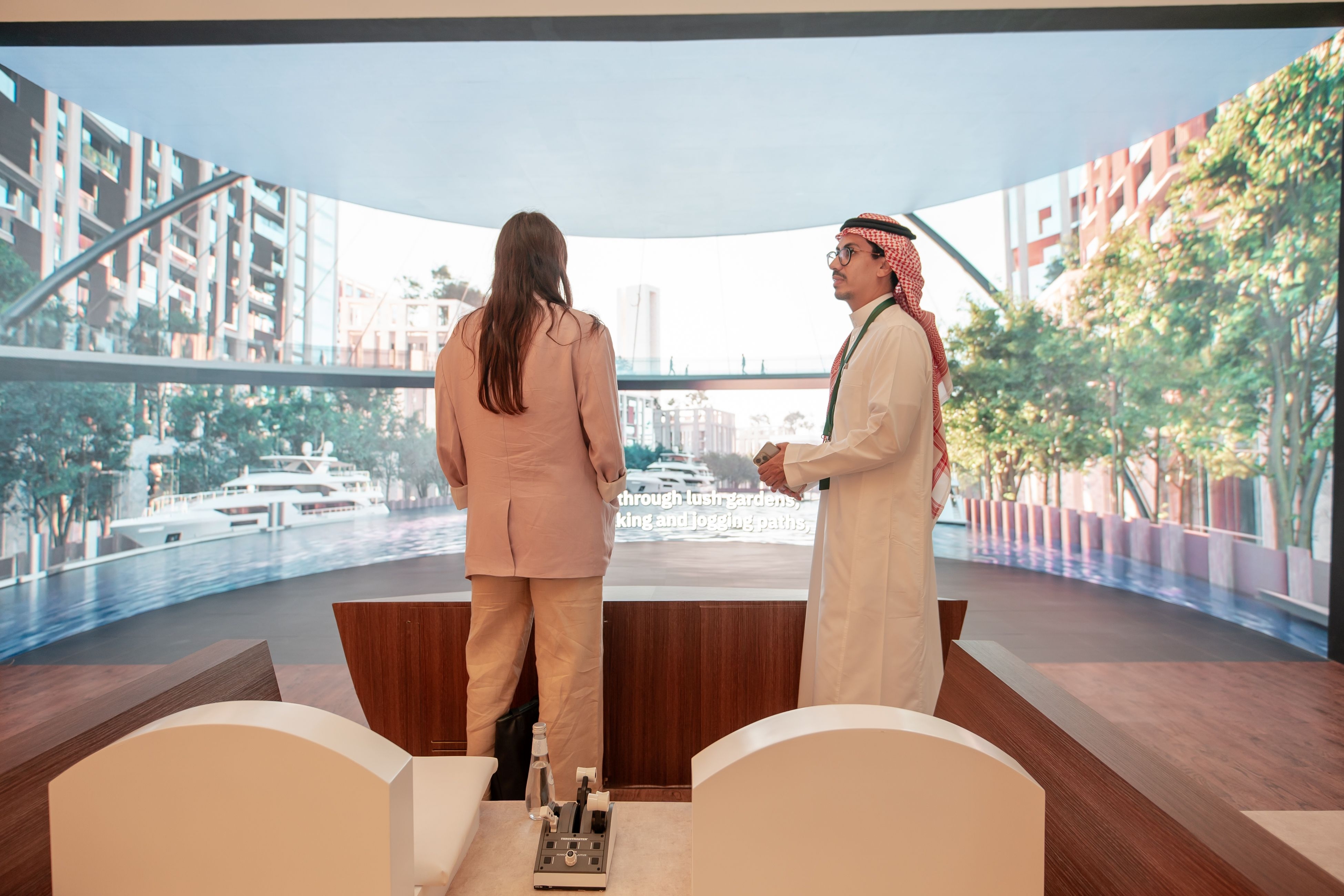 Two people engaged in a discussion about ROSHN Group projects