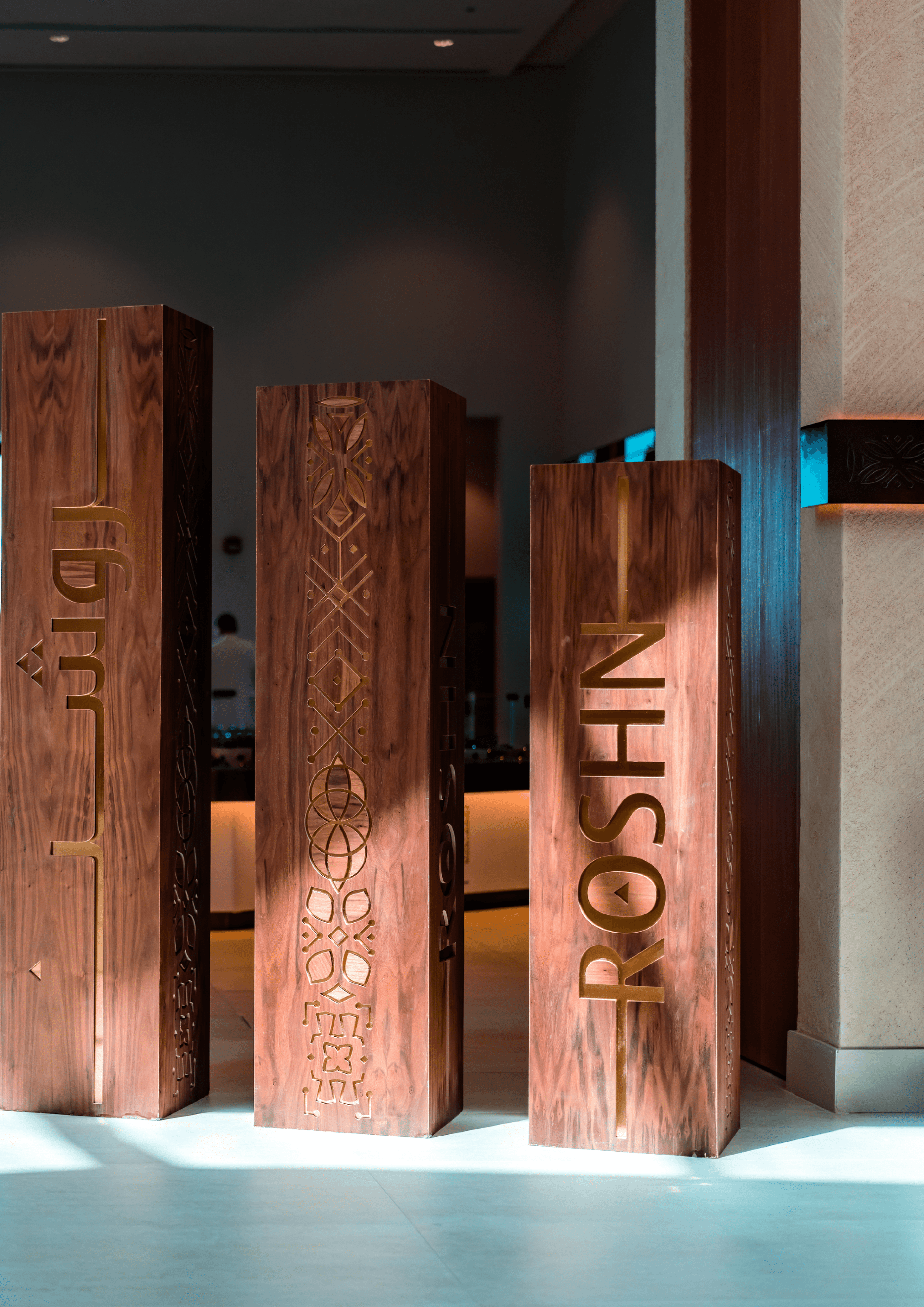 Original ROSHN Group logo engraved on wooden pieces