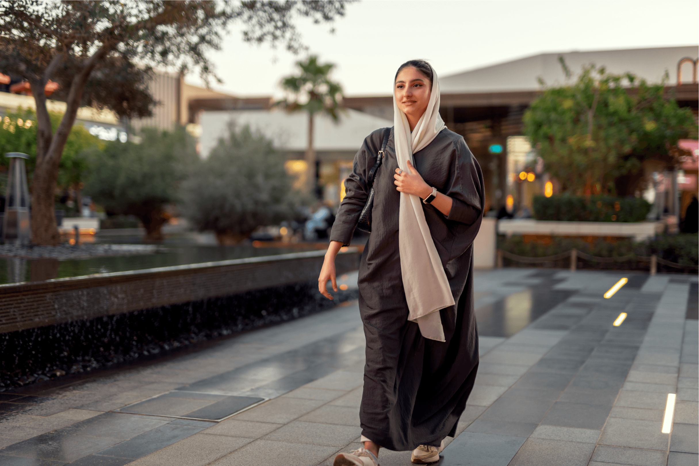 Professional woman walking in a ROSHN Group real estate property